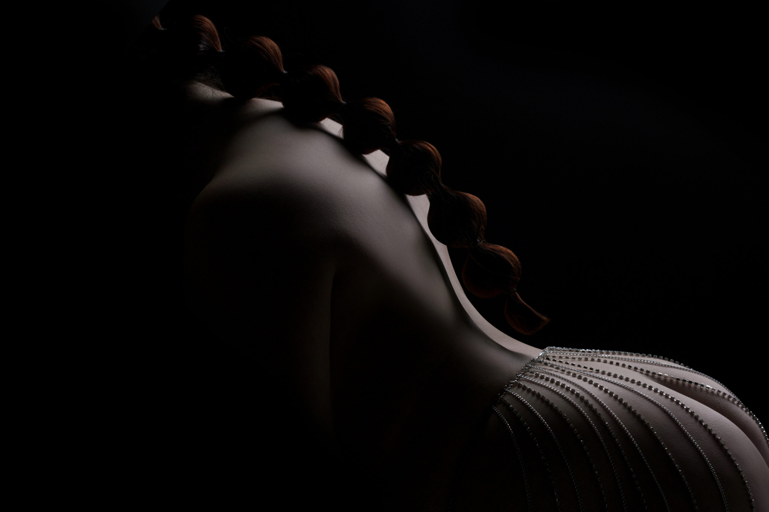 Classy boudoir portrait of Chicago woman wearing silver body jewelry